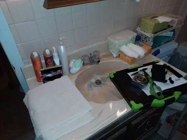 bathroom sink being repaired by a plumber